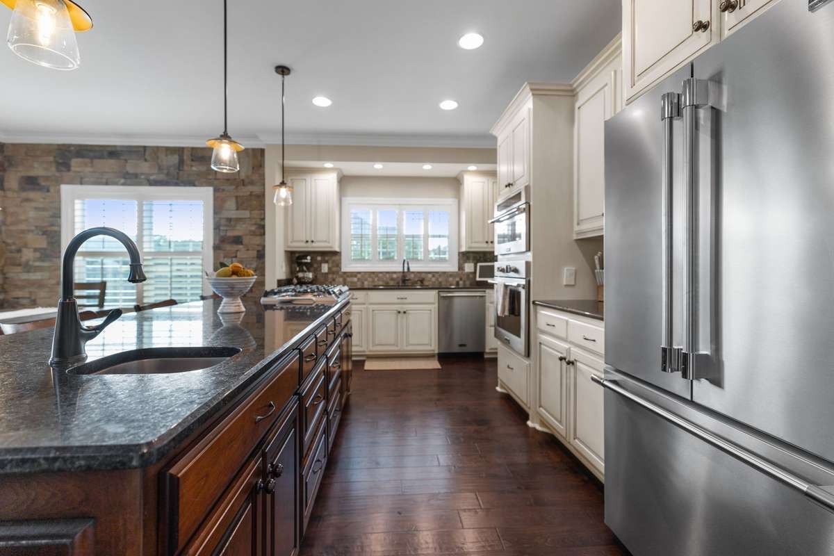 Evening light floods in through plantation shutters, gorgeous views through your kitchen windows overlook the fenced yard.