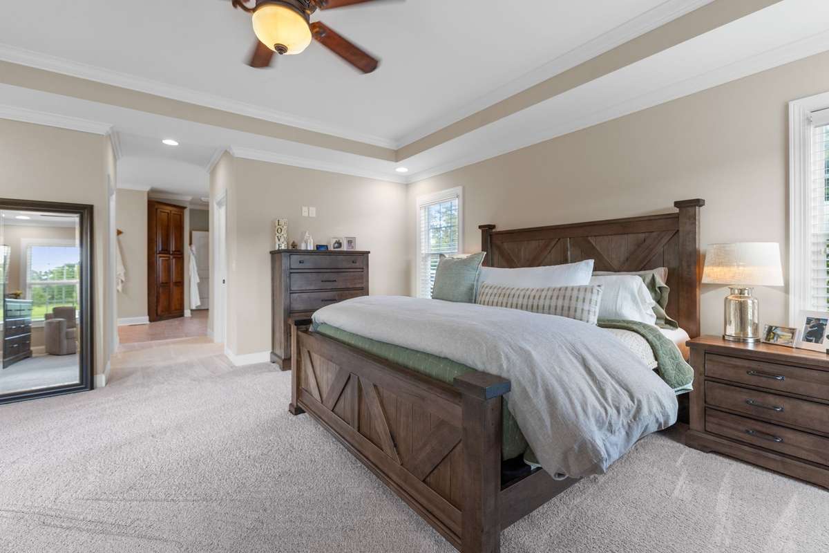 Master bedroom leads into the ensuite master bath with his and her walk-in closets on either side of the entryway.