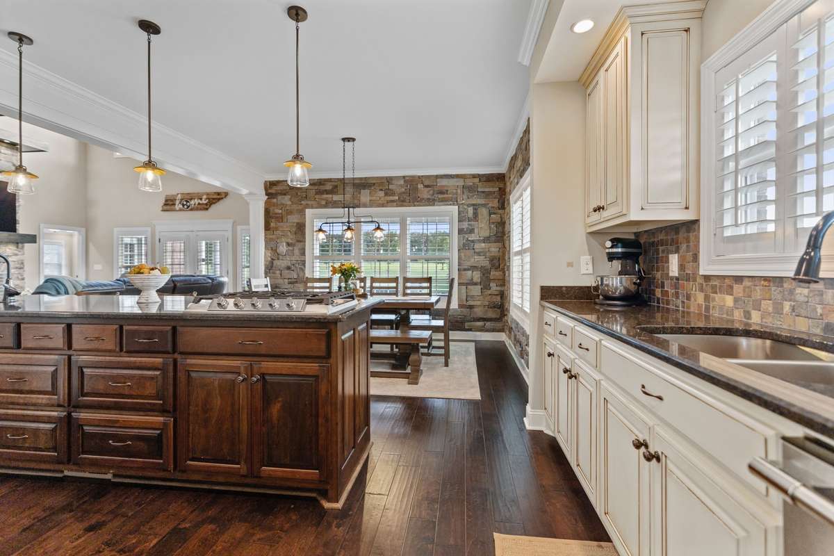 Through the pantry, you enter the kitchen, also open to the living room and dining area.