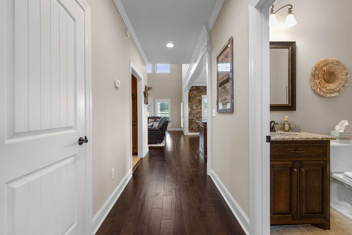 Heading to the stairs from the living room, there is a half bath just off the foyer.