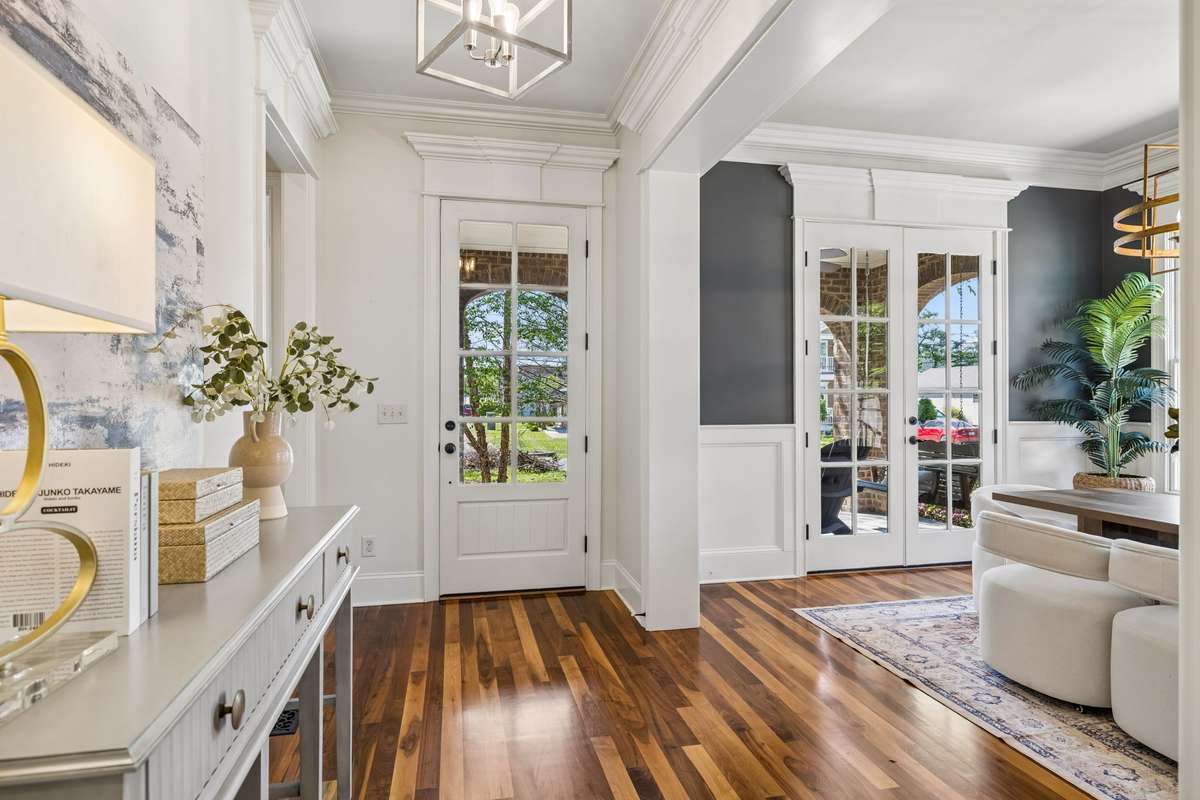 From the moment you step inside, you’re greeted by gleaming hardwood floors that span the entire main level, setting the tone for a home that is both timeless and inviting.