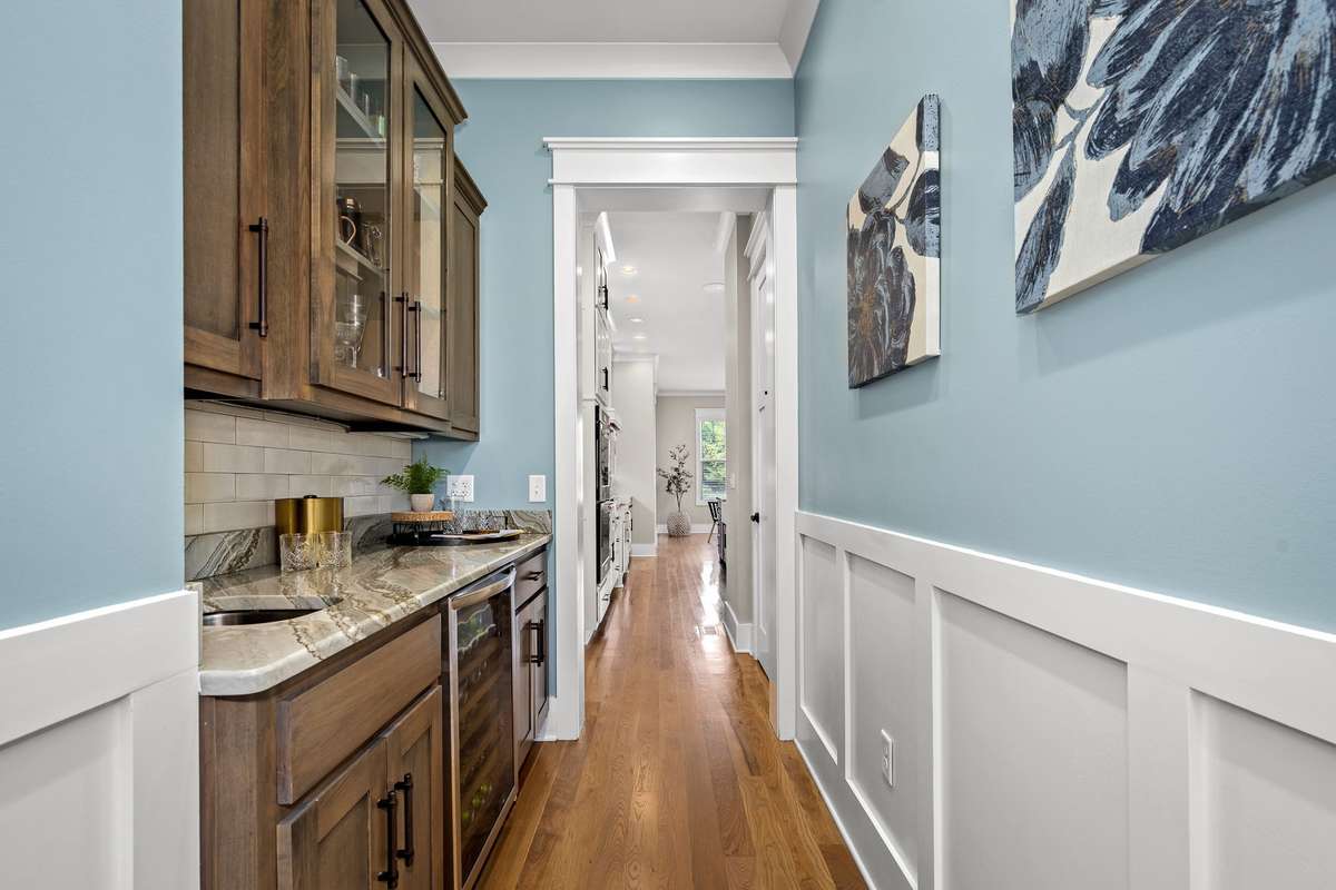 Wine bar area with sink connects the kitchen to formal dining room