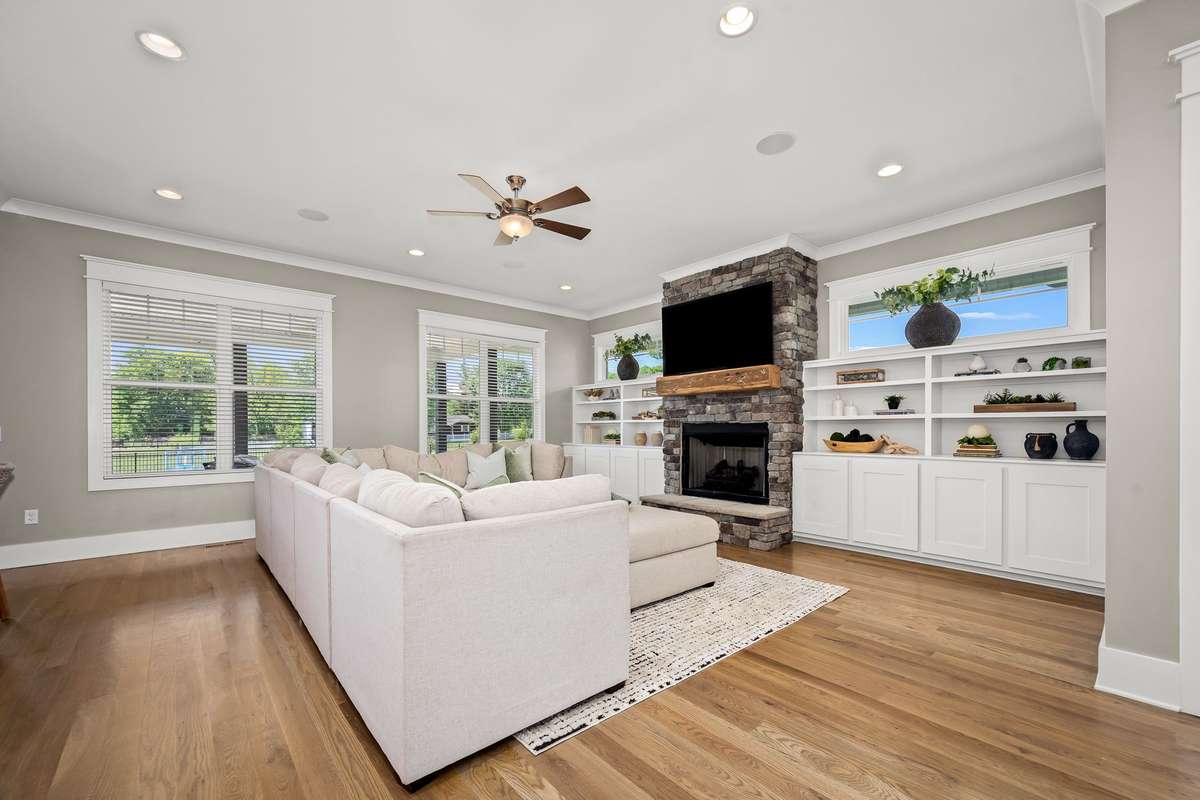 The living room with gas fireplace and built-ins opens up into the eat-in kitchen.