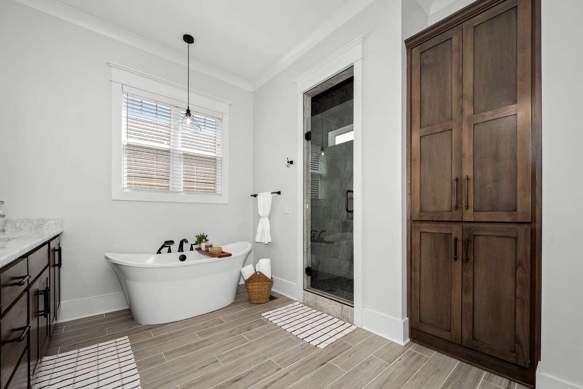 Corner walk-in shower has dual heads.