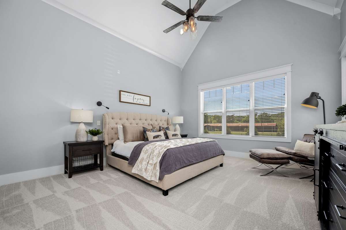 First floor primary suite with cathedral ceiling.