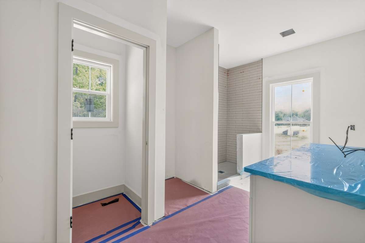 The primary bathroom includes a tiled shower which will complement the tile flooring