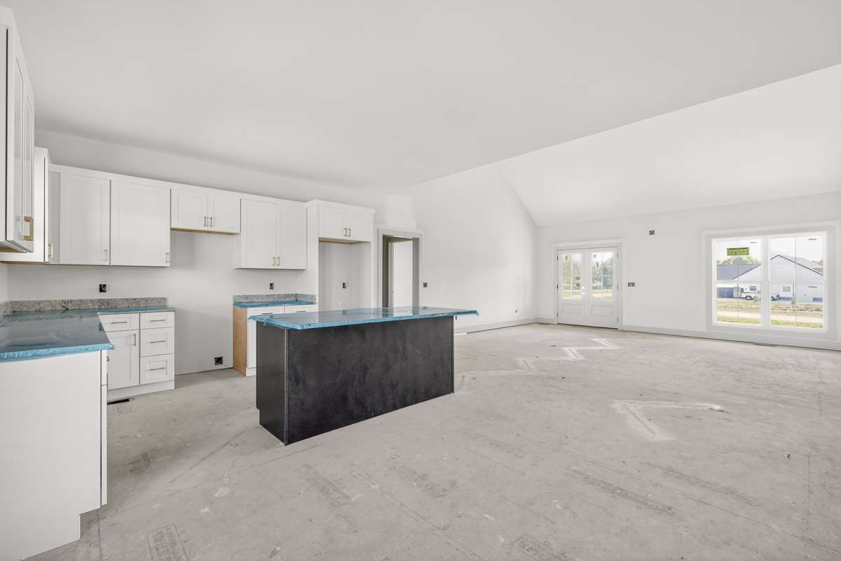 A beautiful modern kitchen with granite countertops and an accented island