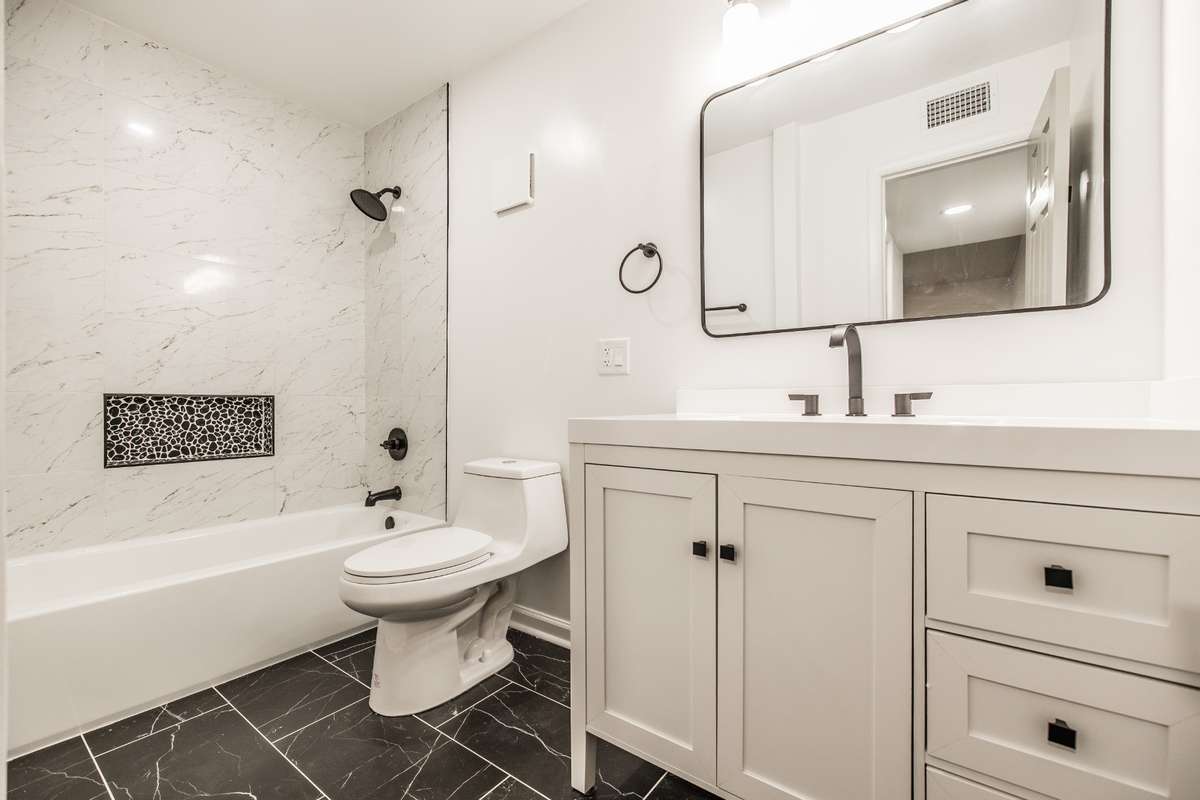 The Primary Suite Bath features black tile, and a large griege vanity. There is plenty of room, and you will love the details