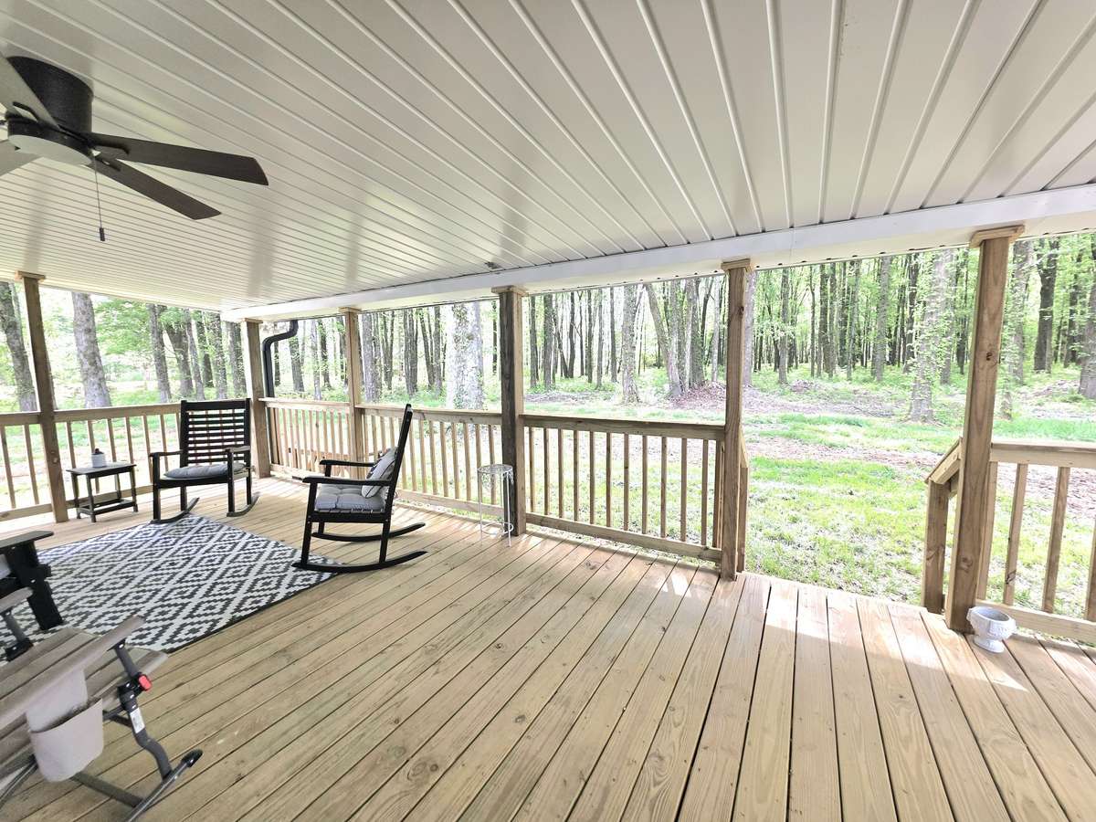 Back deck over looking wooded acres.