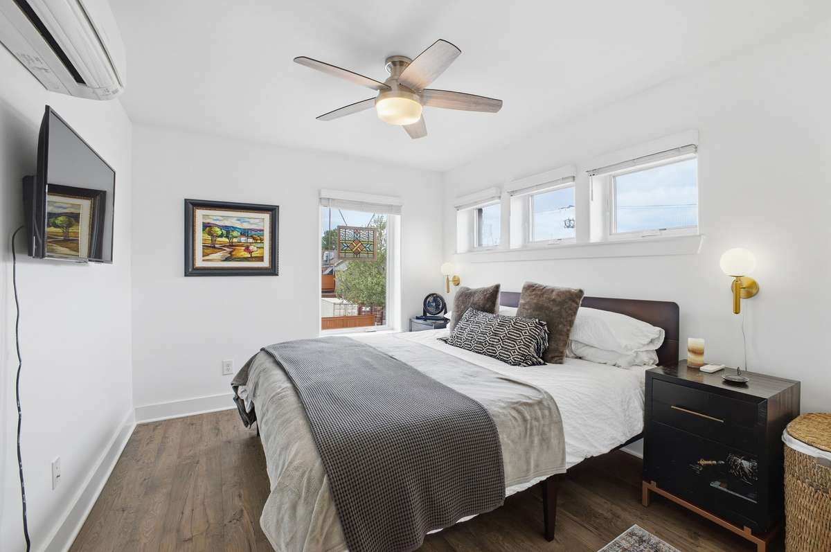 Primary bedroom with plenty of windows allowing fresh breezes when opened.