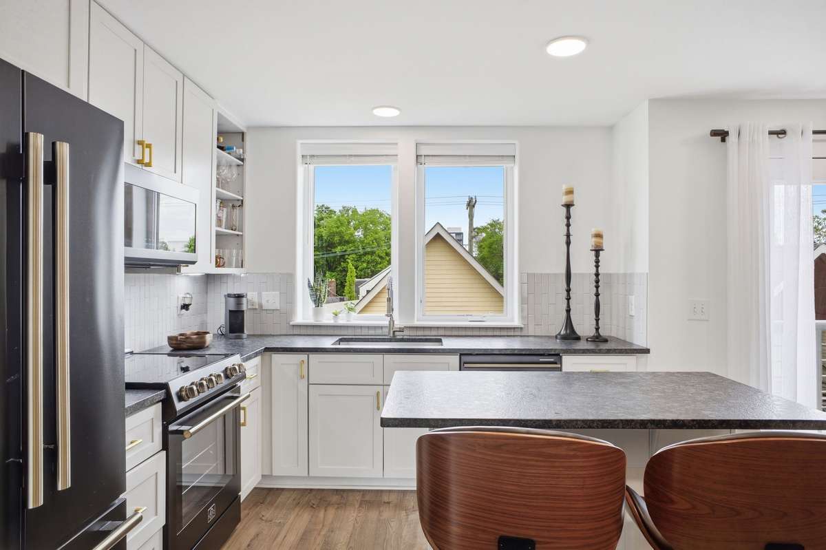 State of art high end kitchen appliances and washer and dryer stack unit.