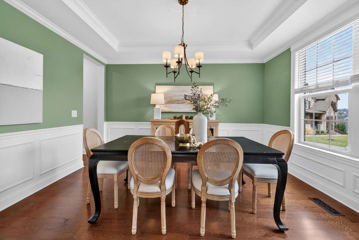 This beautiful formal dining room has a new light fixture, trey ceiling, and loads of natural light. You will love hosting families and friends here.