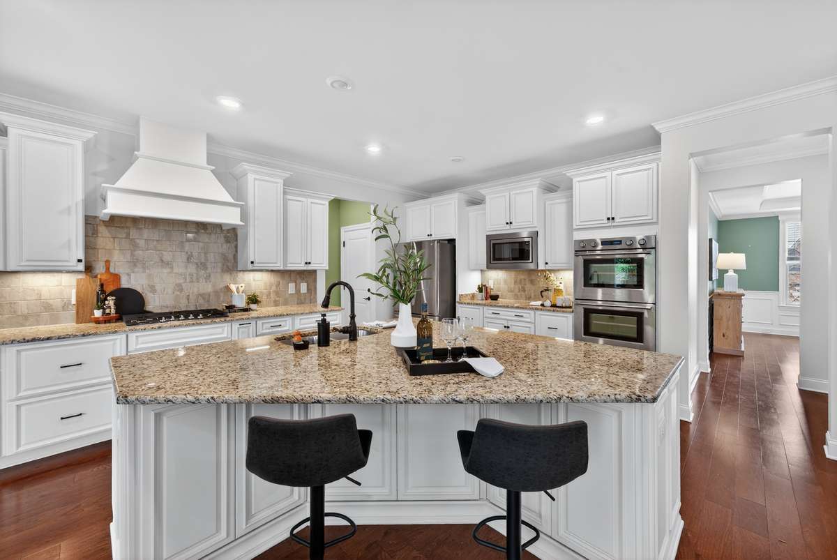 Oversized island with seating—where mornings begin and conversations linger. This chef's kitchen is open to the living room, making this the heart of the home.