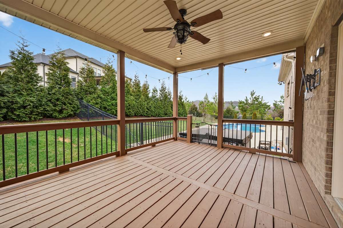 This large covered back patio, has TV hookups and a fan, for creating perfect outdoor living.