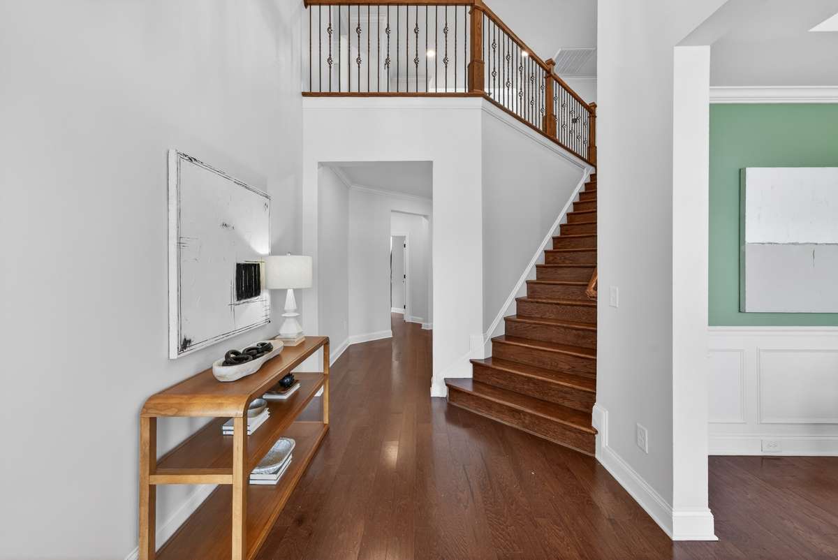 A two story entry foyer sets the tone with scale, light, and an immediate sense of home.