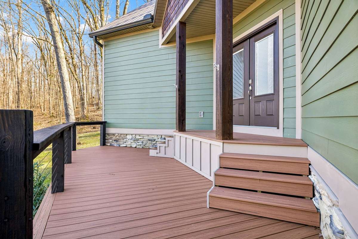 Welcoming entry with low maintenance composite decking and beautiful stone detail, creating a warm and inviting approach.