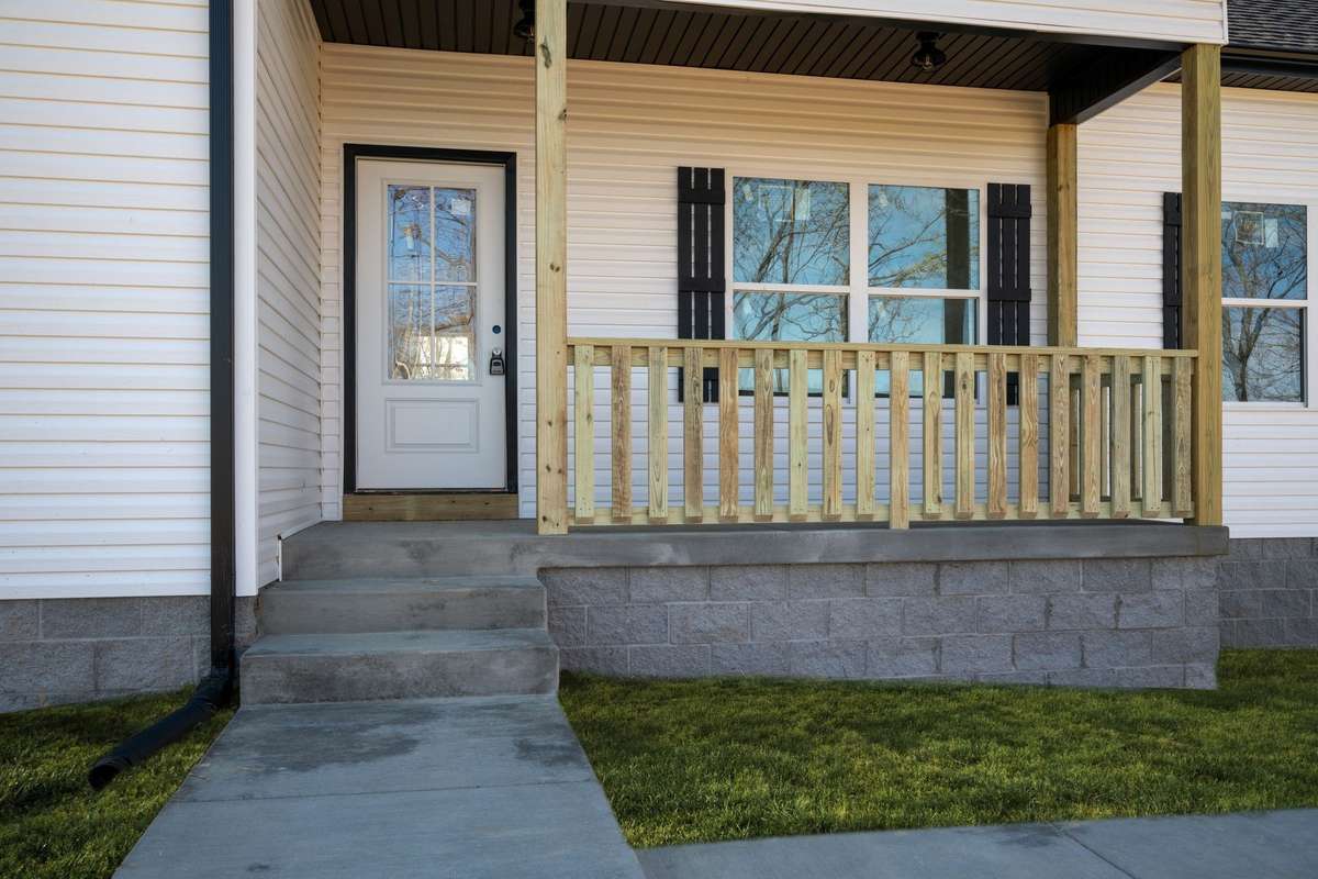 Covered Front Porch + Concrete Sidewalk NOTE: Green Grass Edits on Exterior Photos