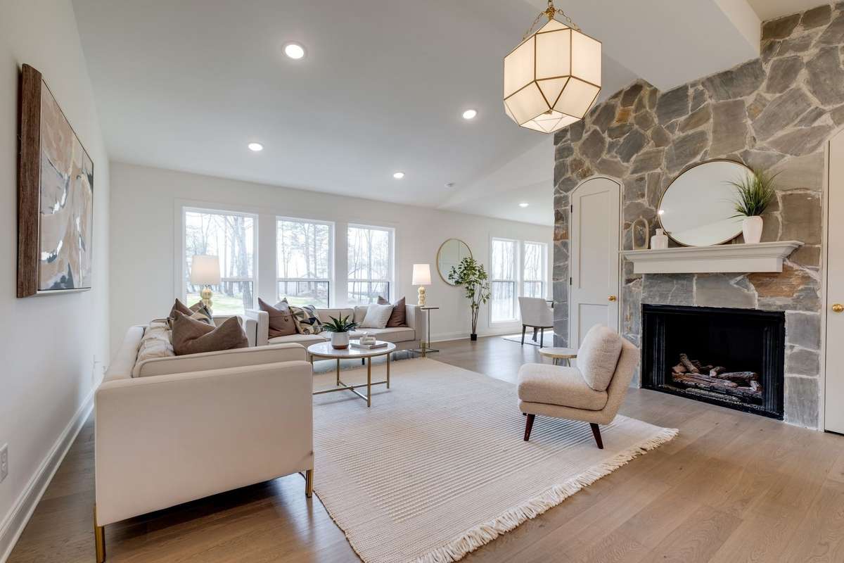 IMPRESSIVE Great Room featuring Gas Fireplace + Stone Accent Wall