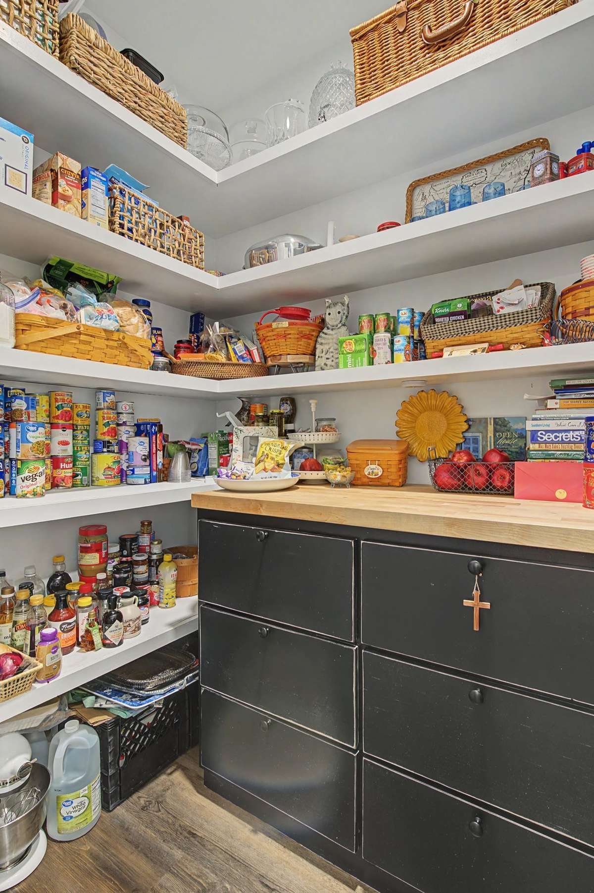 Pantry has custom shelving on all three walls and the newer custom cabinet adds storage and prep space.