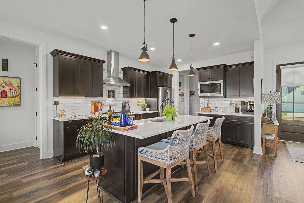 Granite countertops with tile backsplash and new lighting.  Refrigerator stays with the home.