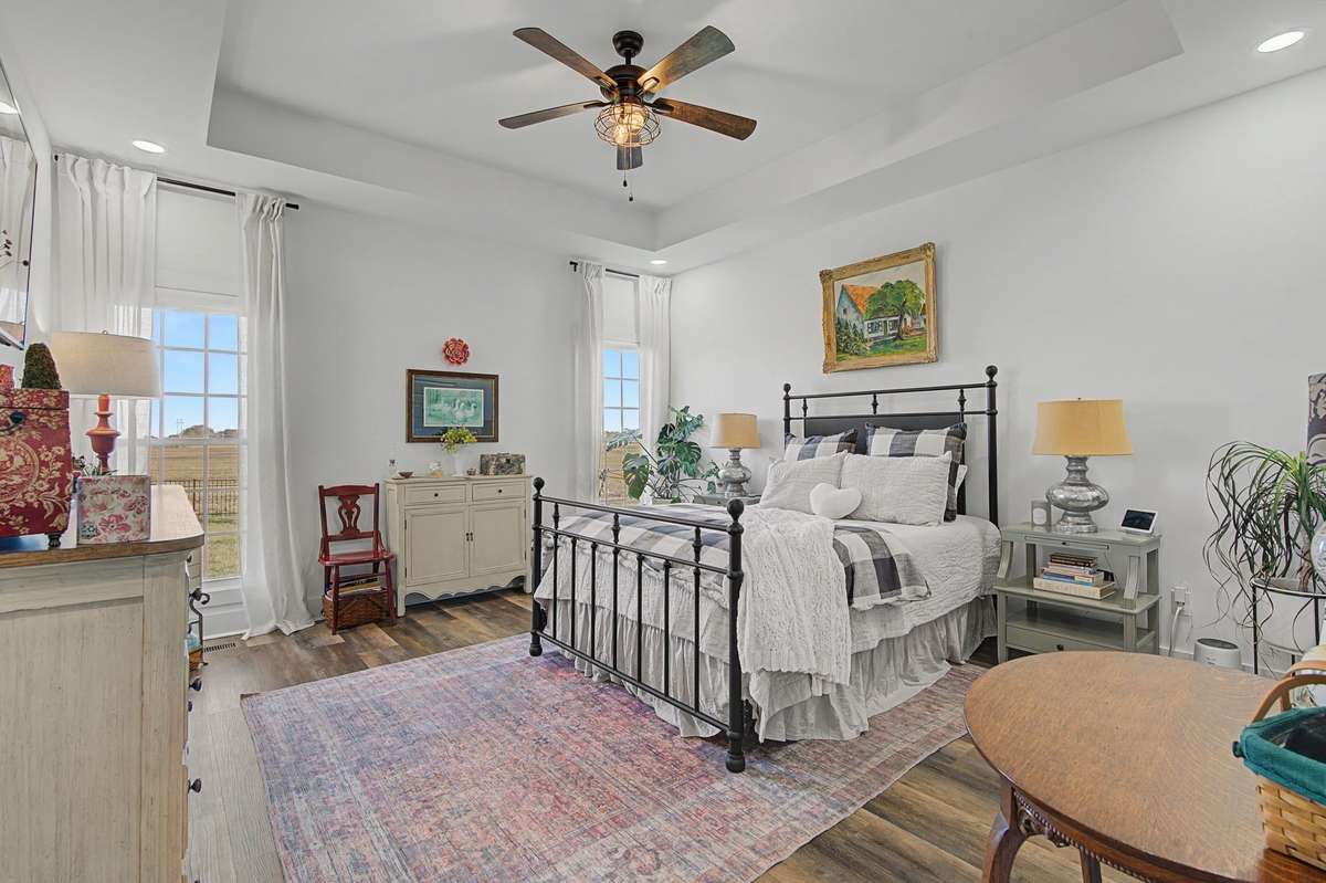 Primary bedroom with trey ceiling.