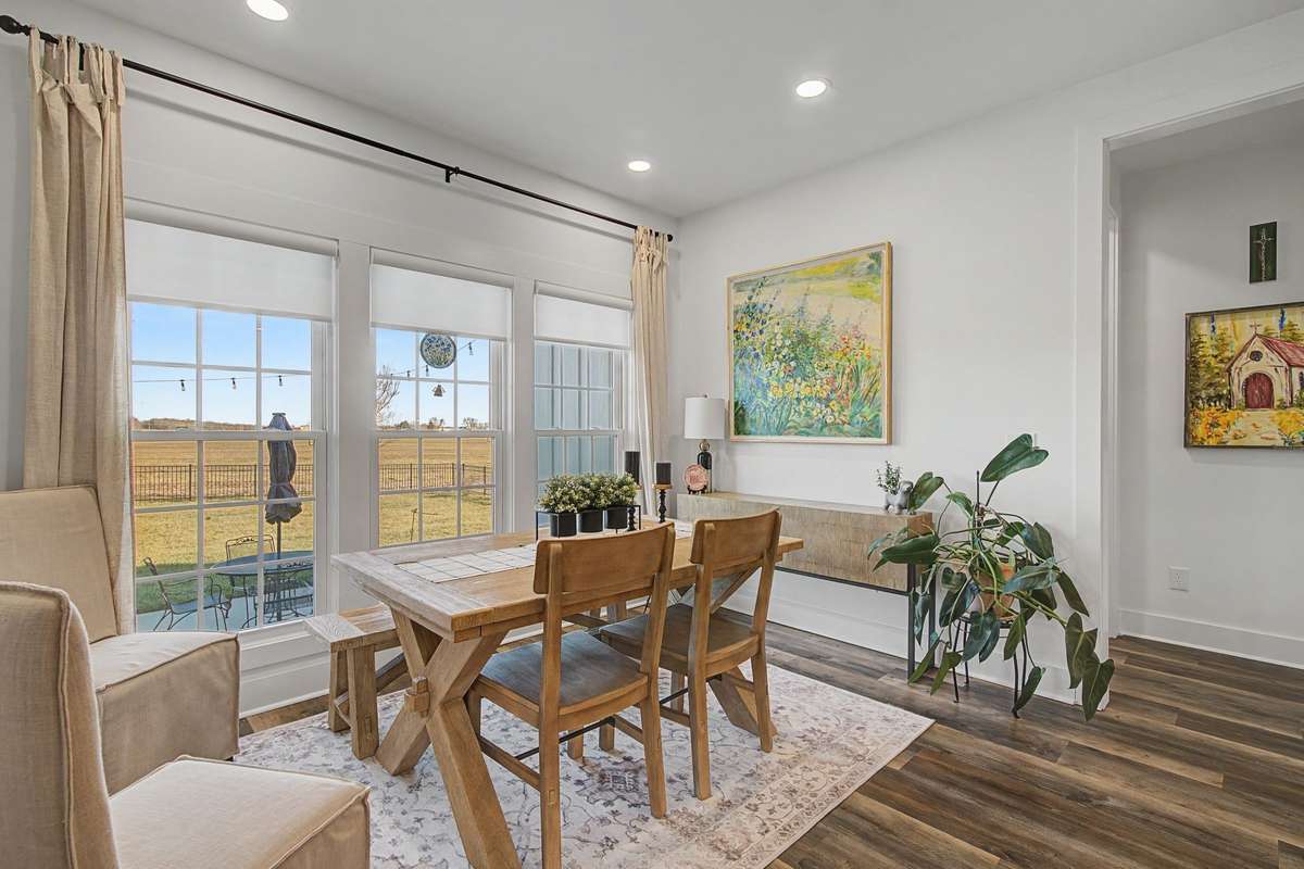 So much natural light and custom blinds in the dining room.