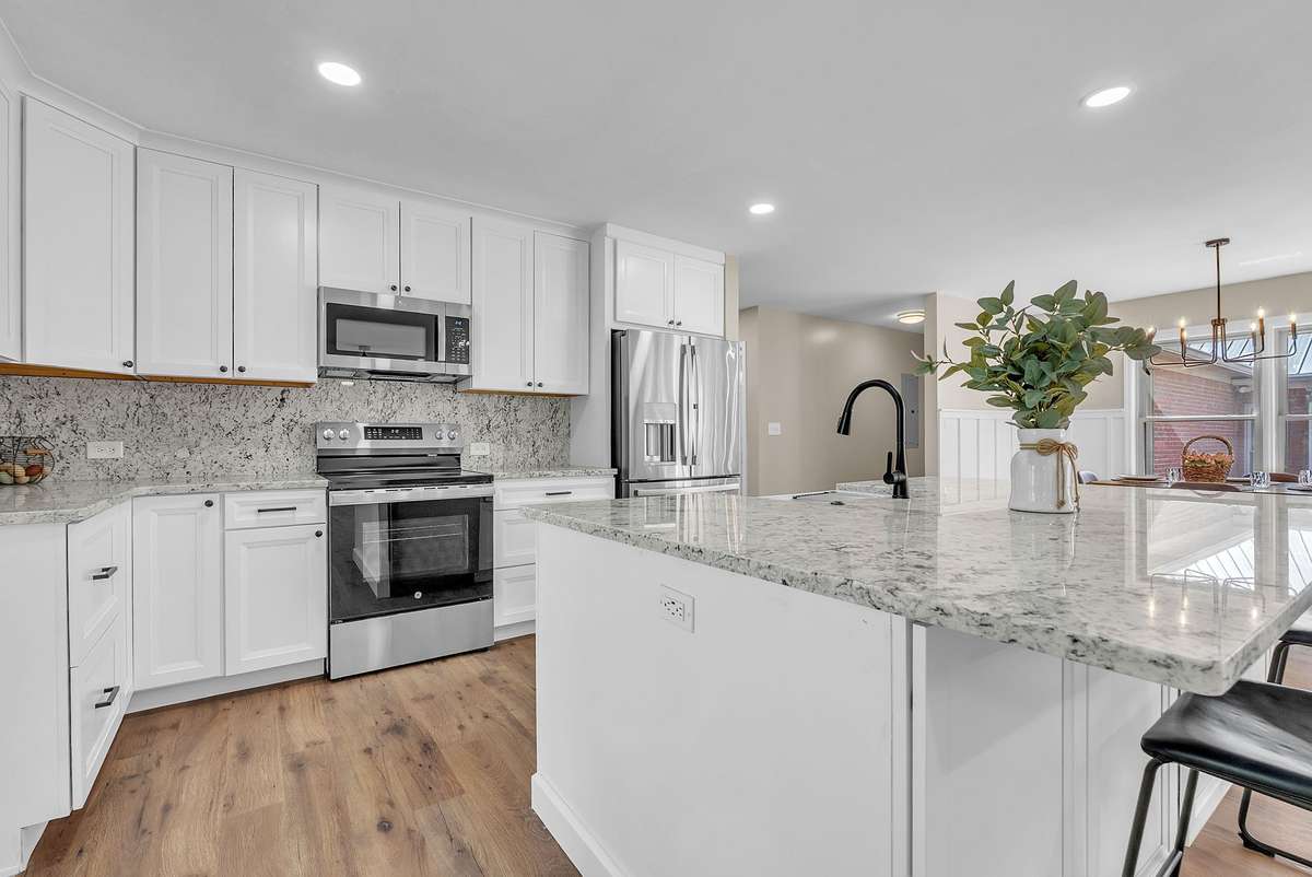 The heart of the home.  Open concept kitchen with beautiful new white shaker style cabinets,
matte black hardware, and all new GE Profile kitchen appliances. “White
Ice” Granite countertops, backsplash, and huge island 7’6” by 5’1”