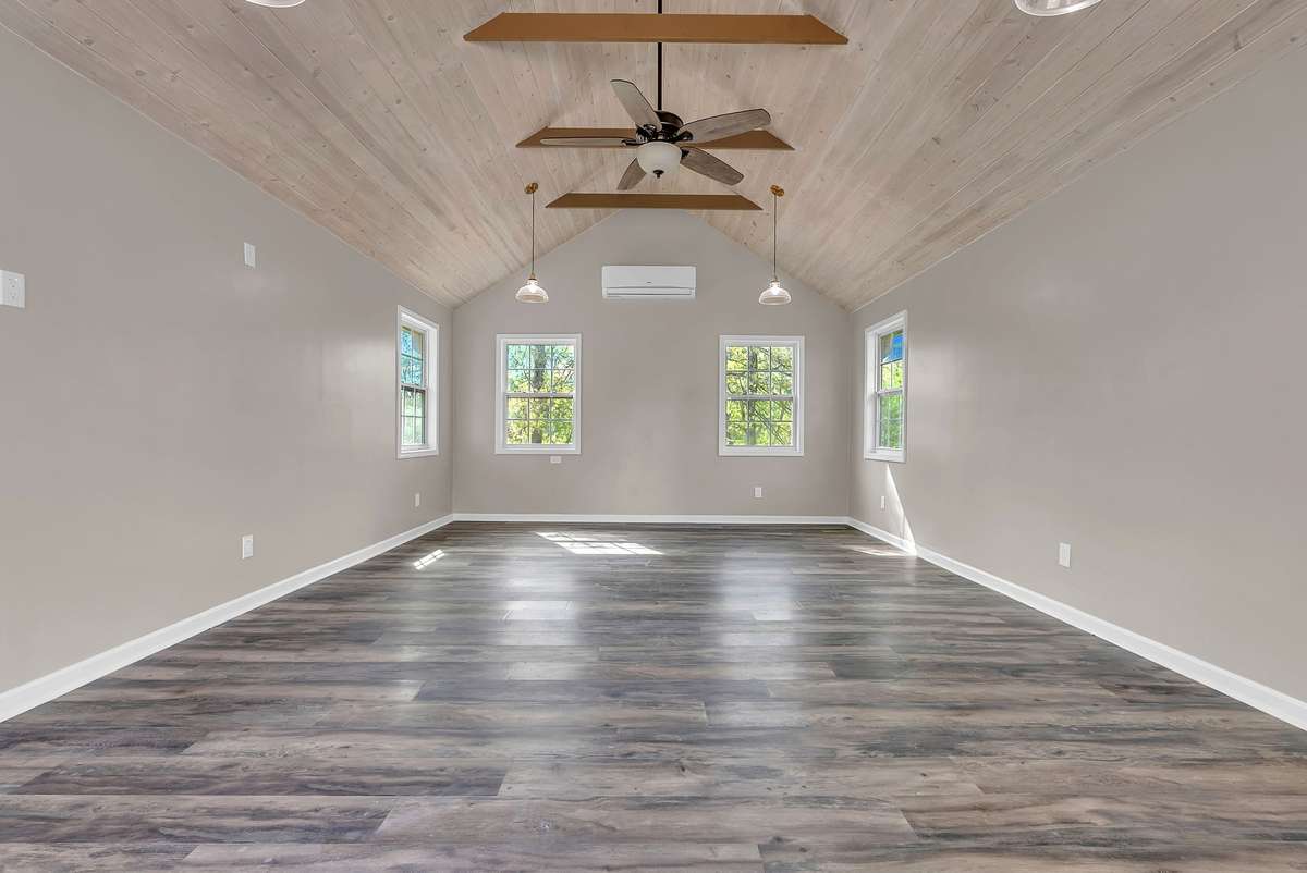 This adorable guest cottage or flex space is a showstopper—cute curb appeal, concrete driveway, and surrounded by mature trees. Perfect home office, music studio, quilting room, craft room with total privacy. Heated and cooled