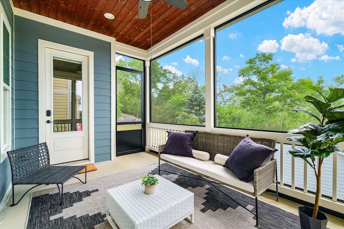Beautiful screened in porch overlooking the fenced back yard.