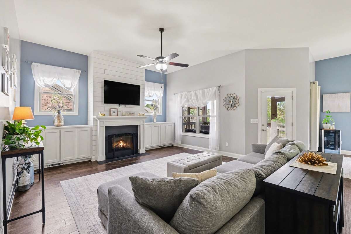 Large living room with rich wood flooring.