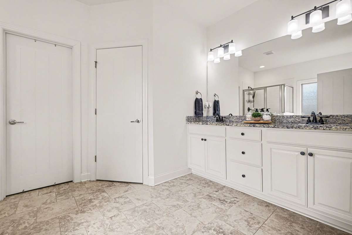Primary bathroom. Beautiful granite countertops, double vanity, soaker tub with separate shower!! Large walk in closet!