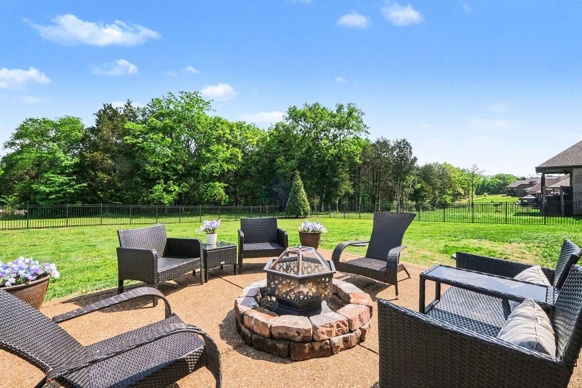 Enjoy this firepit in the fenced in back yard.
