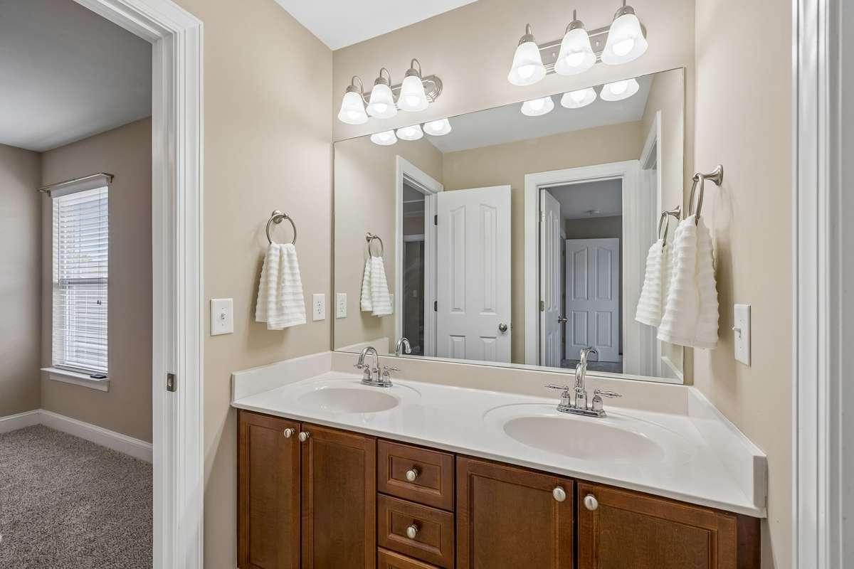 Upstairs Bath between Two Bedrooms with Double vanities and separate shower area