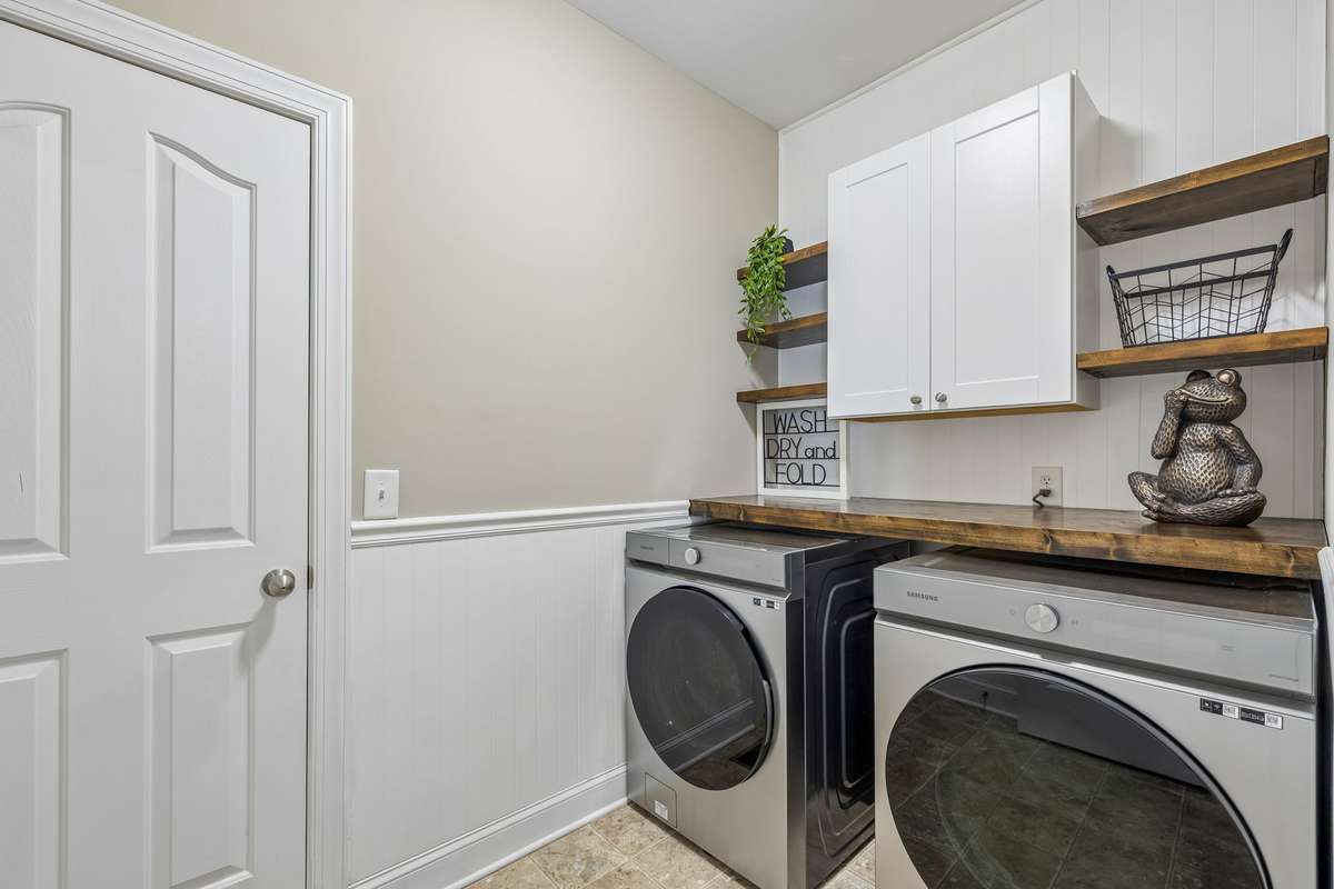 Laundry room with cabinet and Open Shelving as well as folding space