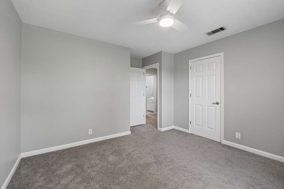 A view from the front upstairs bedroom showing closet door and the door leading to hallway.