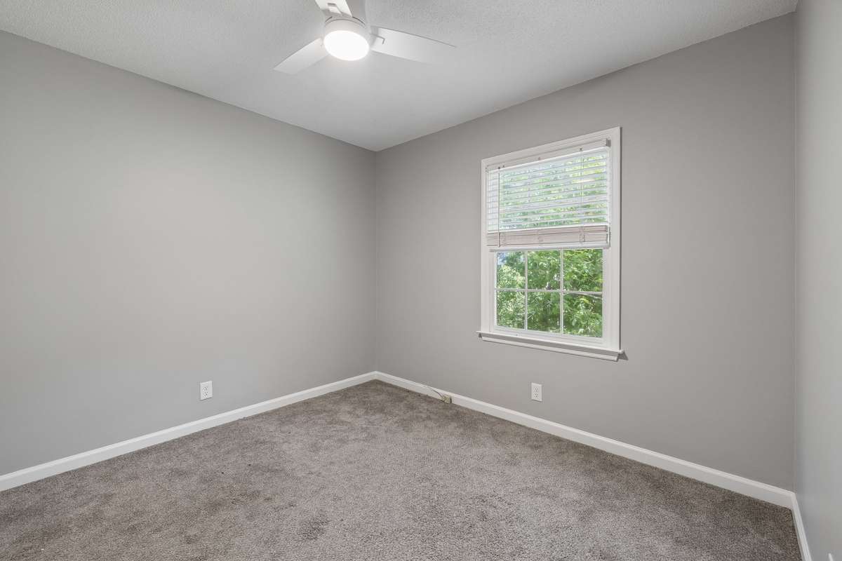 A view of the second upstairs bedroom from the hallway. New ceiling fan. Nice-sized window for good, natural light and offering a fine view of backyard.