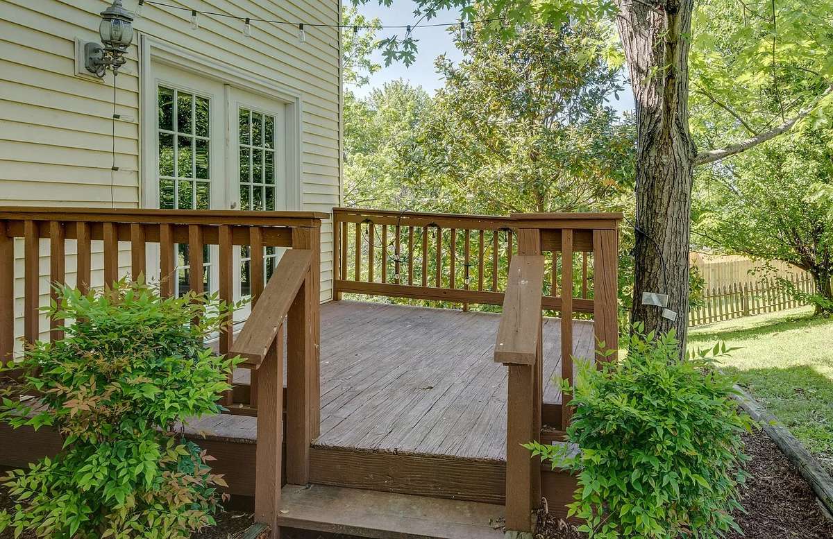 The deck has overhead Edison Lights and an easy two step walk into the backyard.