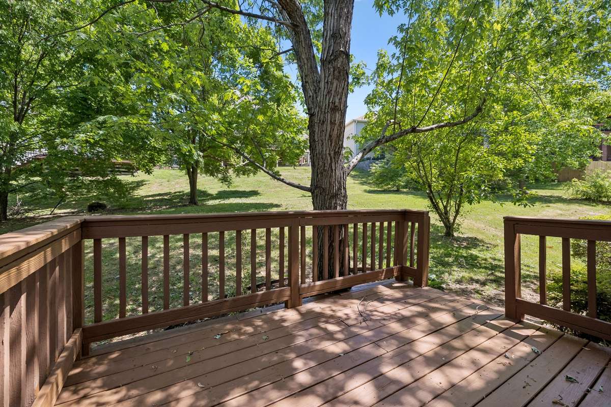 A view of the deck at the rear of the house. It's just been re-stained and a few old boards were replaced.  There's a lovely view into the backyard!