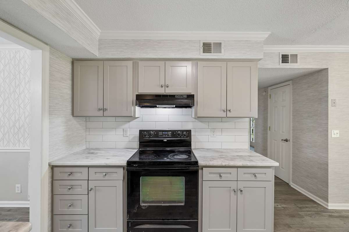 The countertops are sometimes mistaken for Carrera marble, but they are, in fact, granite, which offers heat resistance and durability.  All kitchen cabinetry has been professional painted in the past month and new overhead lights have been installed