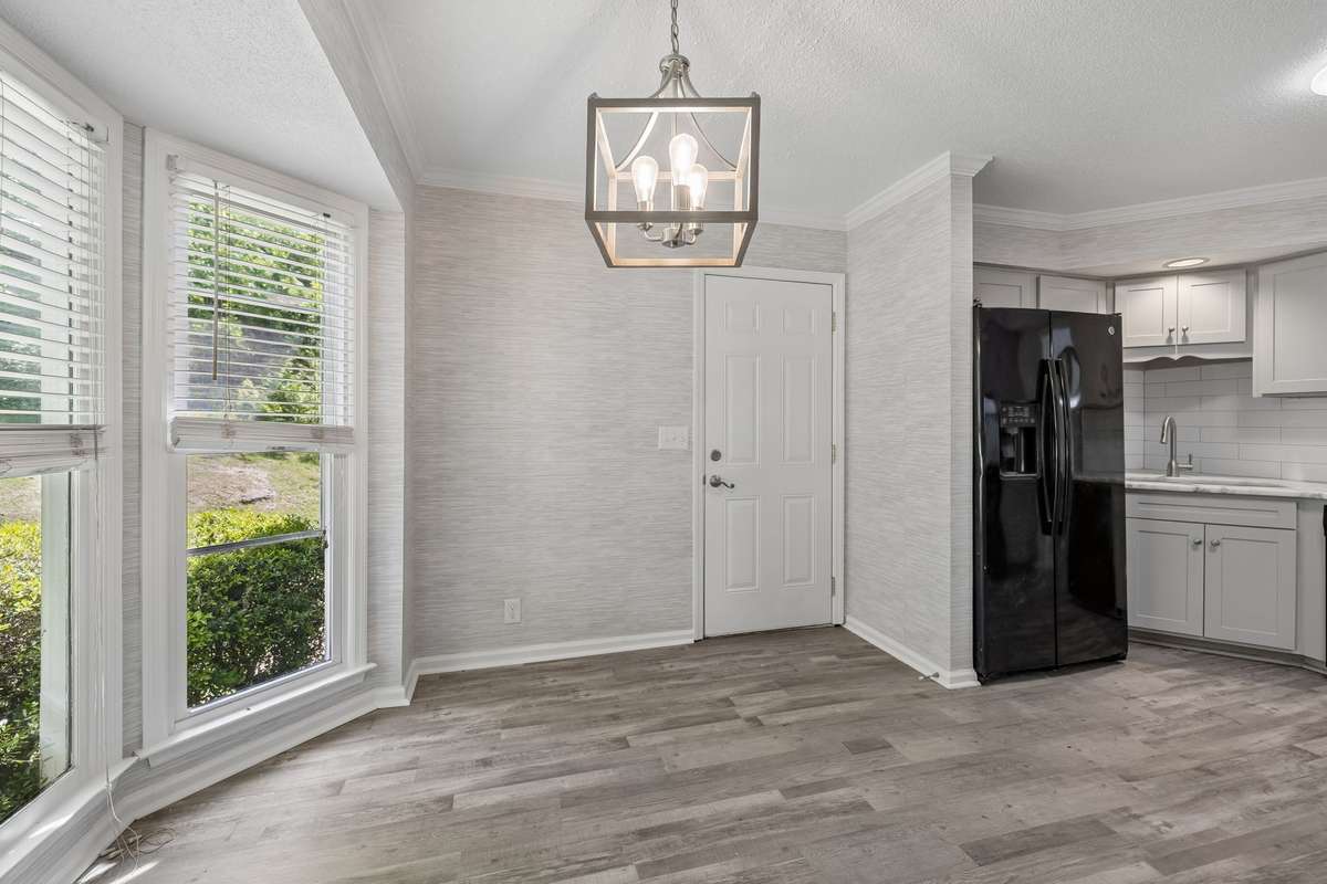 A view of the breakfast nook facing the door into the attached, 2 car garage.  The kitchen area is to the right of the photo.