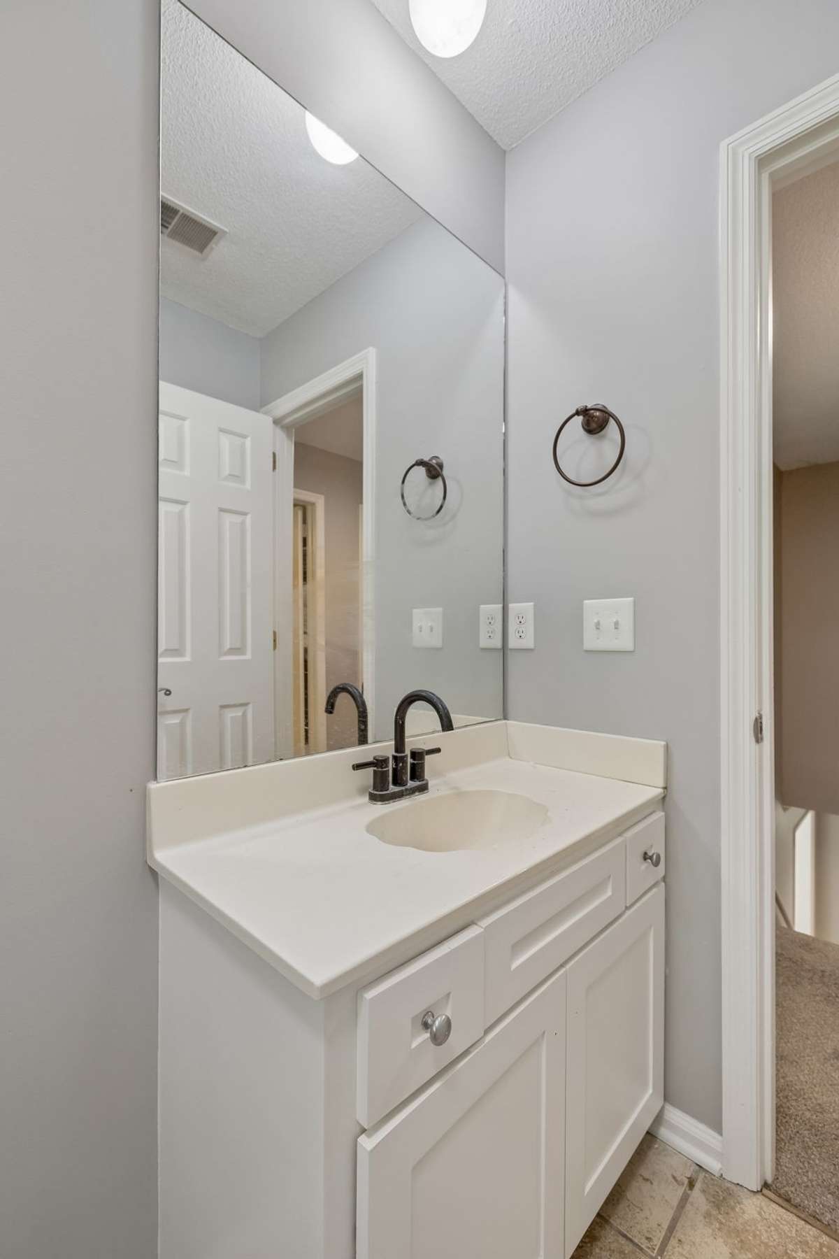 The second bathroom vanity allows storage. New faucet and new lighting.