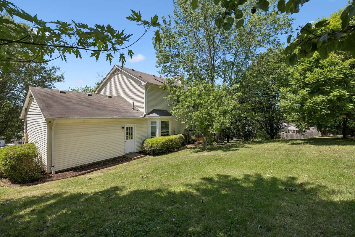 A view of the home's backyard. Mature trees. Large size due to the home's pie-shaped lot.