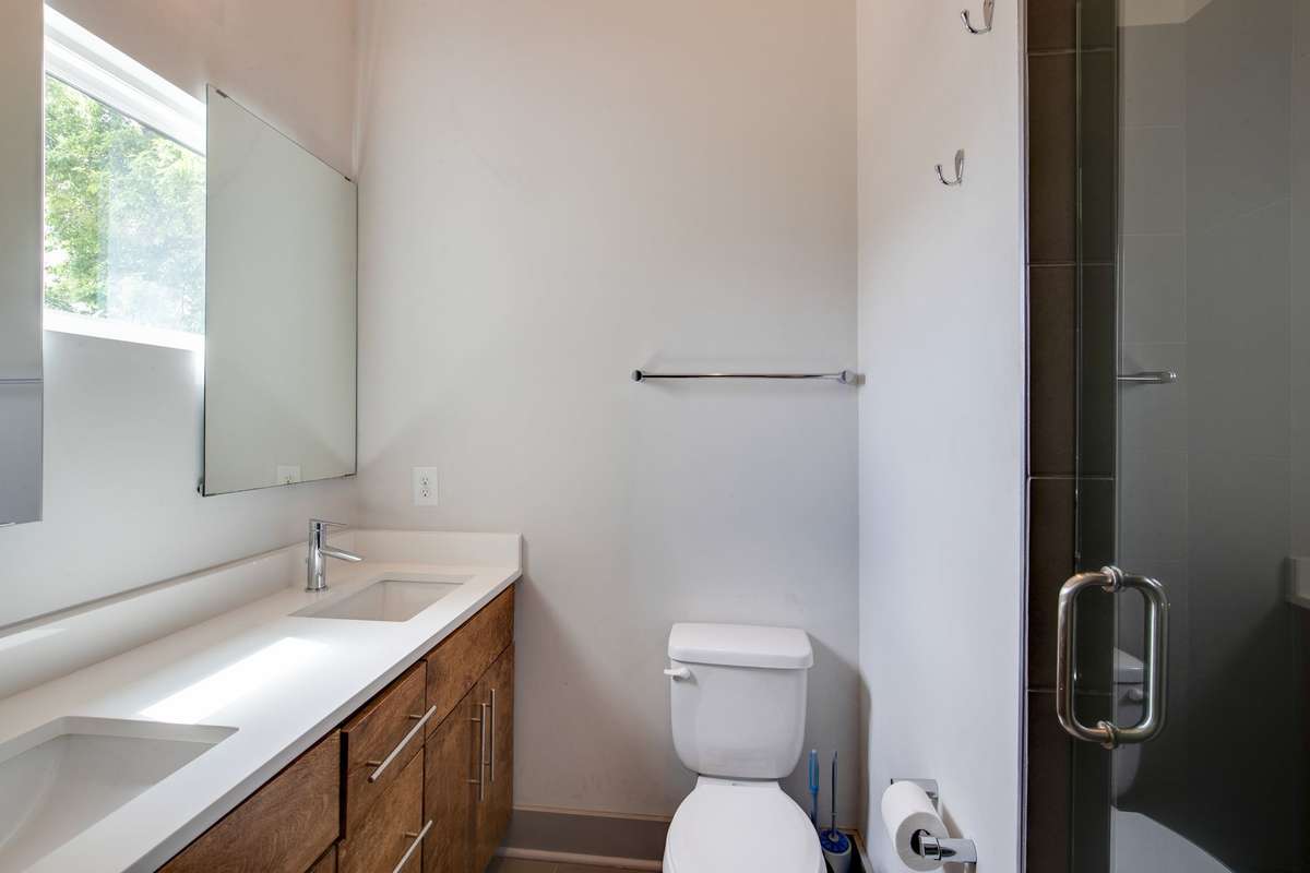 Double vanities and tiled shower in primary bathroom.