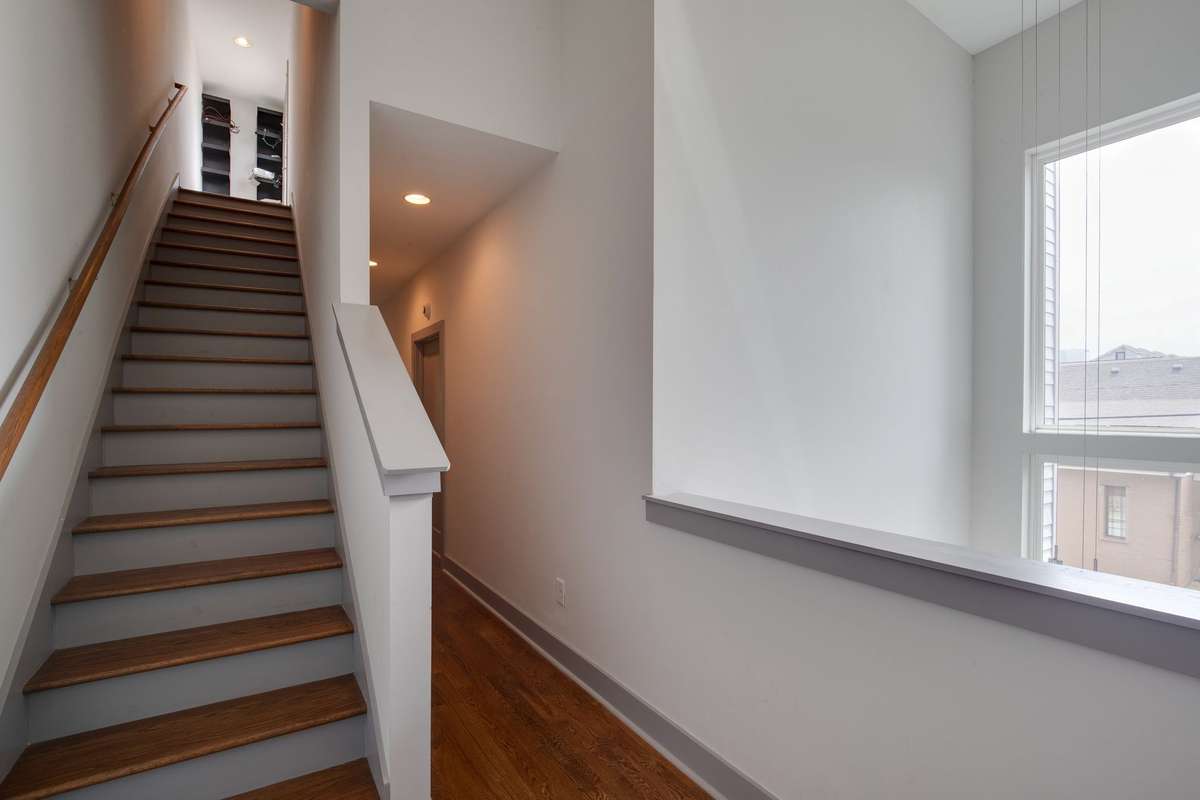 Stairs leading to upstairs rooftop deck.