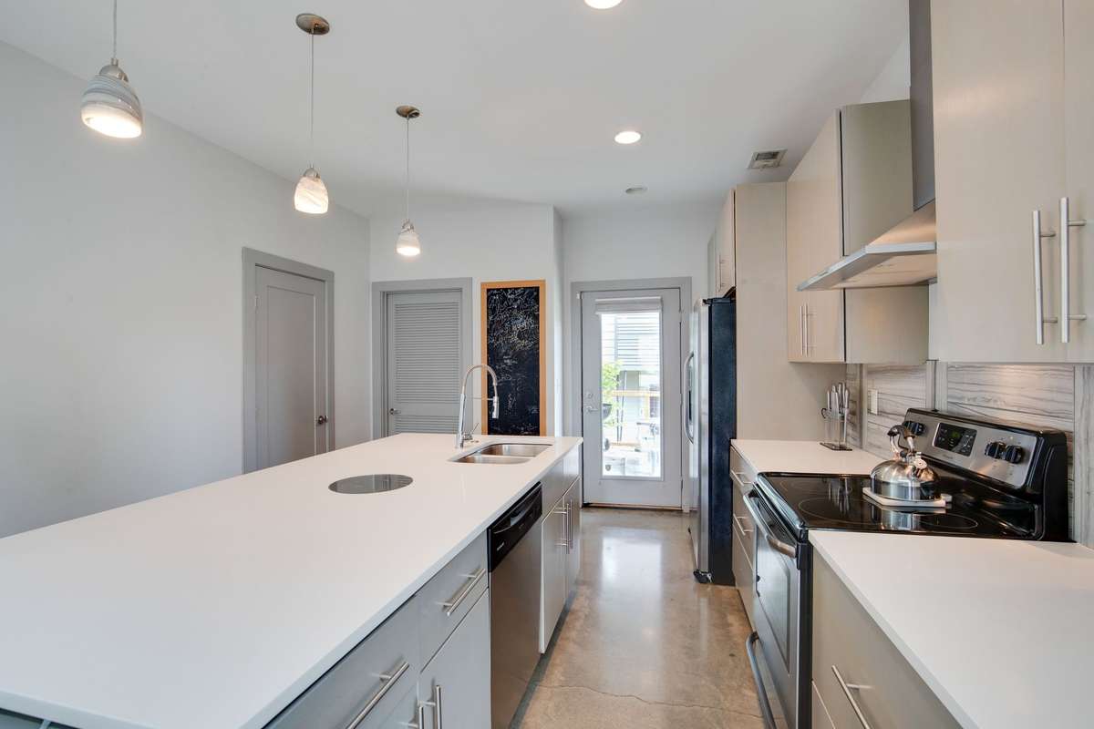 Kitchen leads to back patio and fenced in yard.
