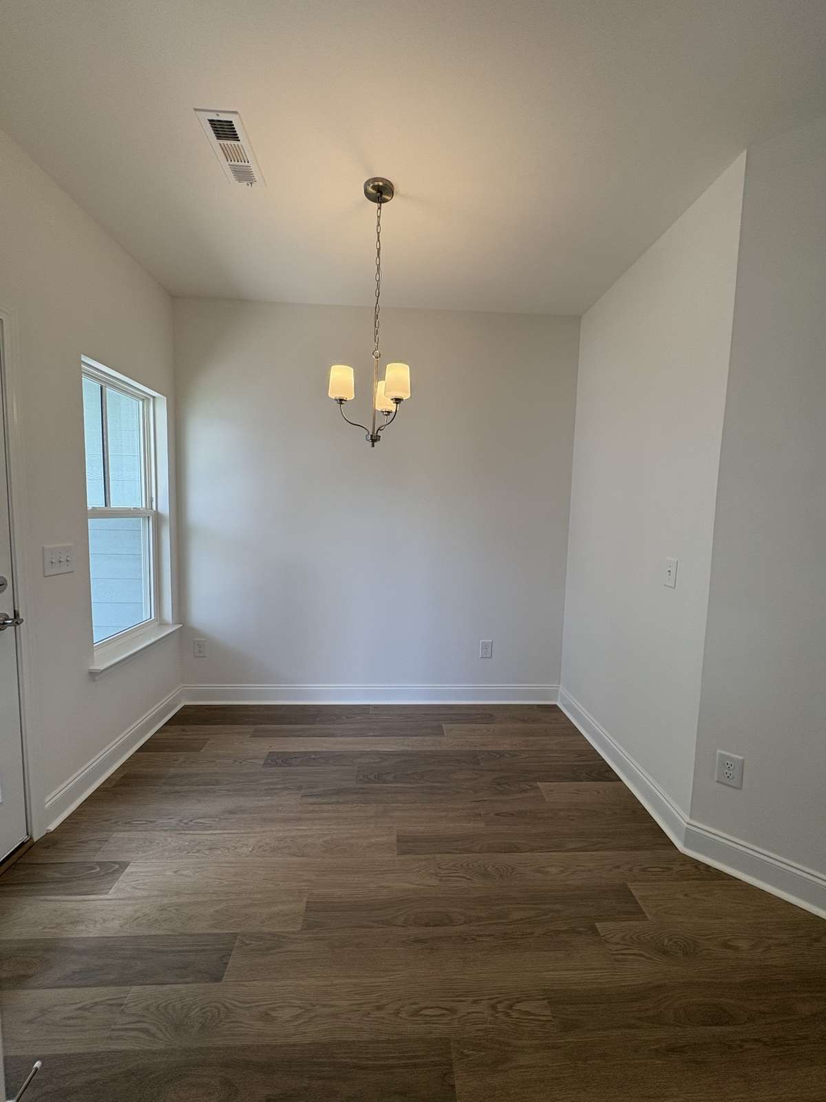 Breakfast nook off of kitchen.  Patio door to garage and courtyard entrance here