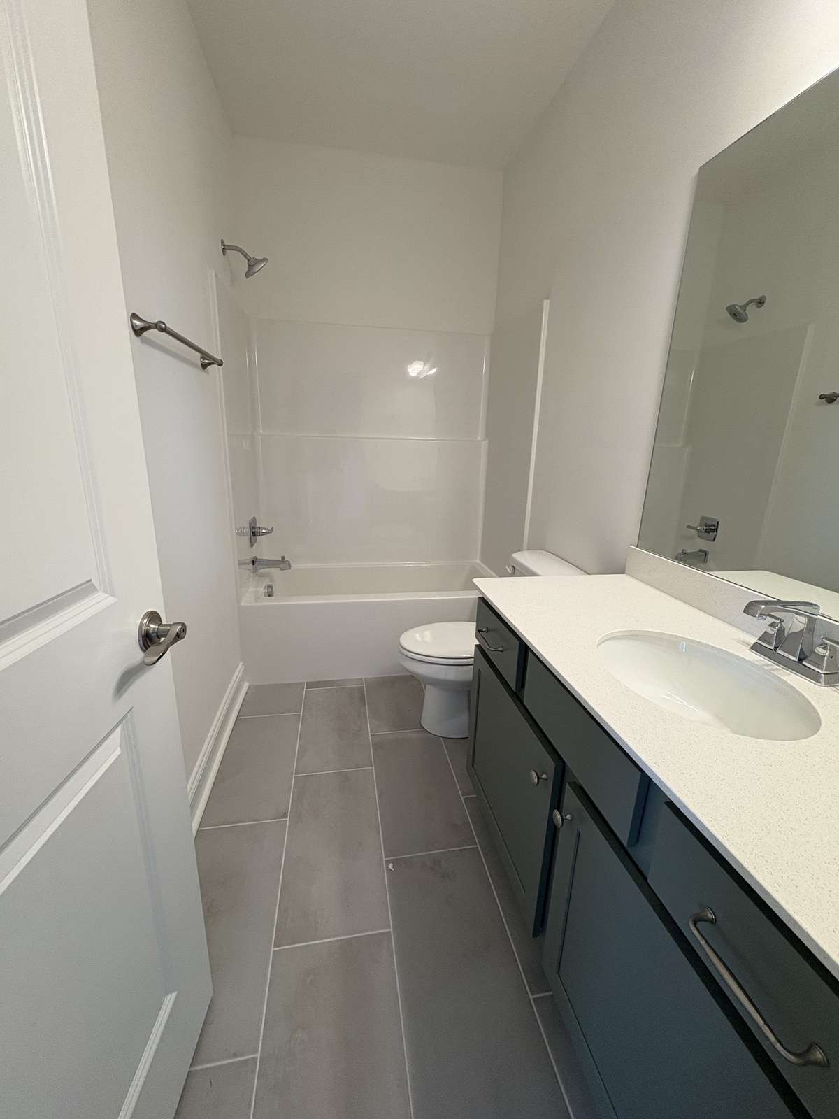 hall bath with tub/shower combo.  Large vanity top
