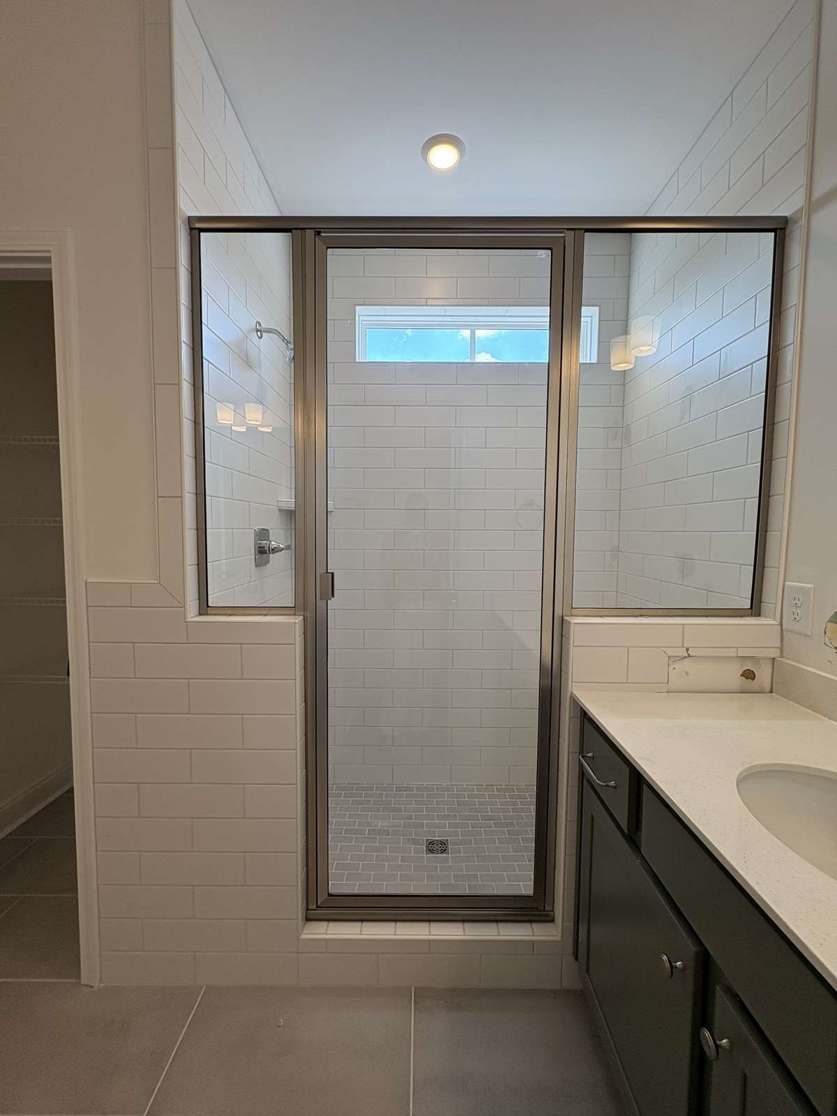 Tiled shower with Bench in Master Bath.  Tile floors.  Split vanity with quartz counters