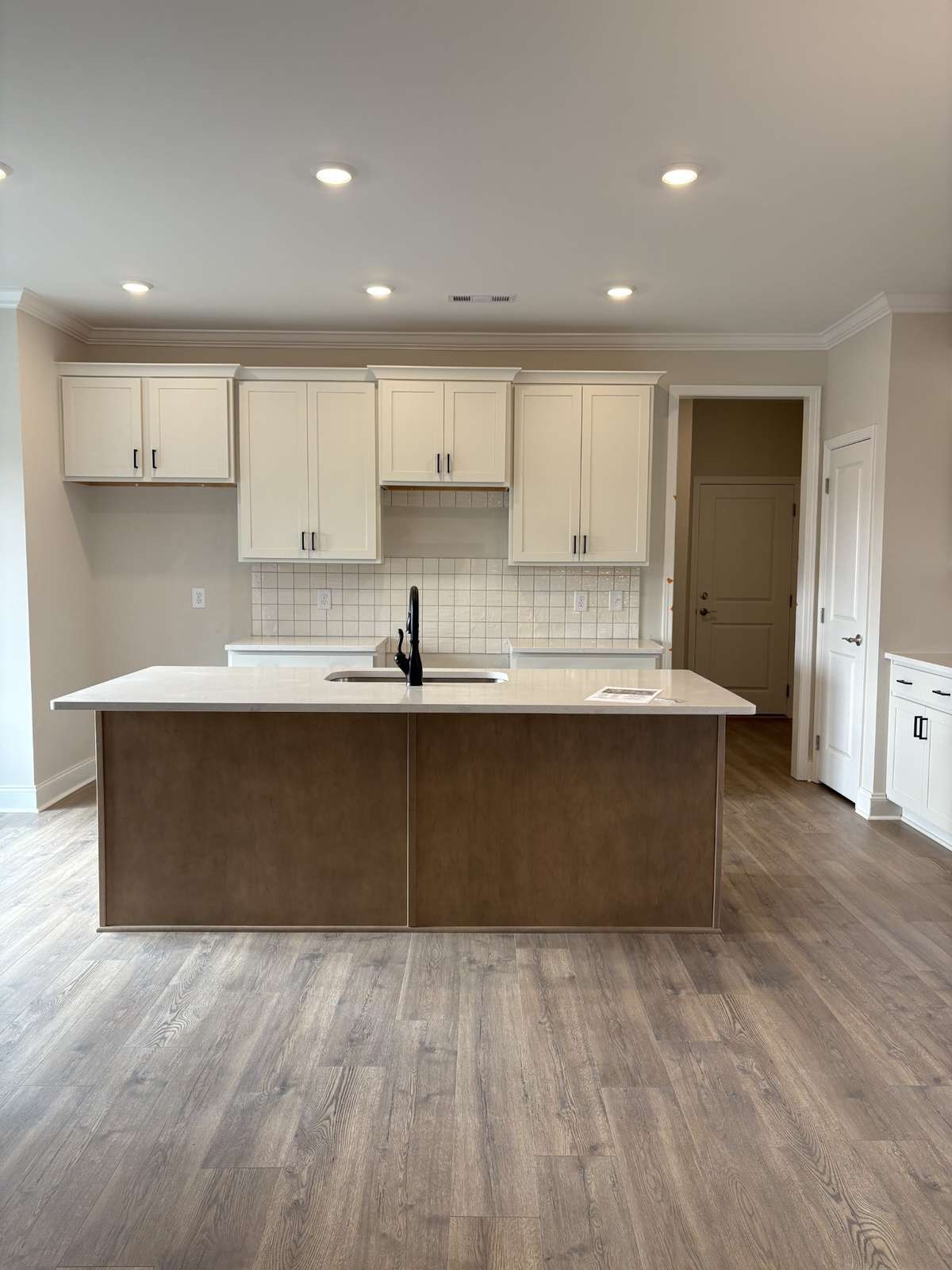 Great kitchen with White cabinets and Brown stained cabinet island. Stubbed for gas if you'd like a gas range.