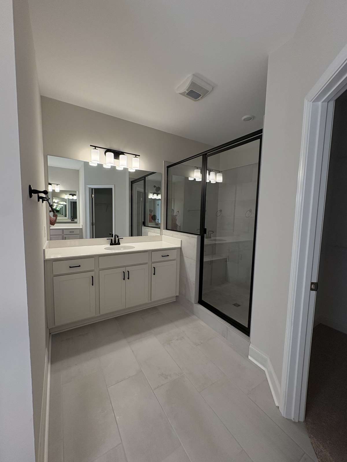 Tiled floors and shower.  Quartz counter top with under mount sinks. Water closet.  Large walk in closet